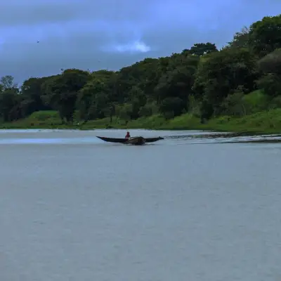 Canoa ao longe, recortada pela linha da mata